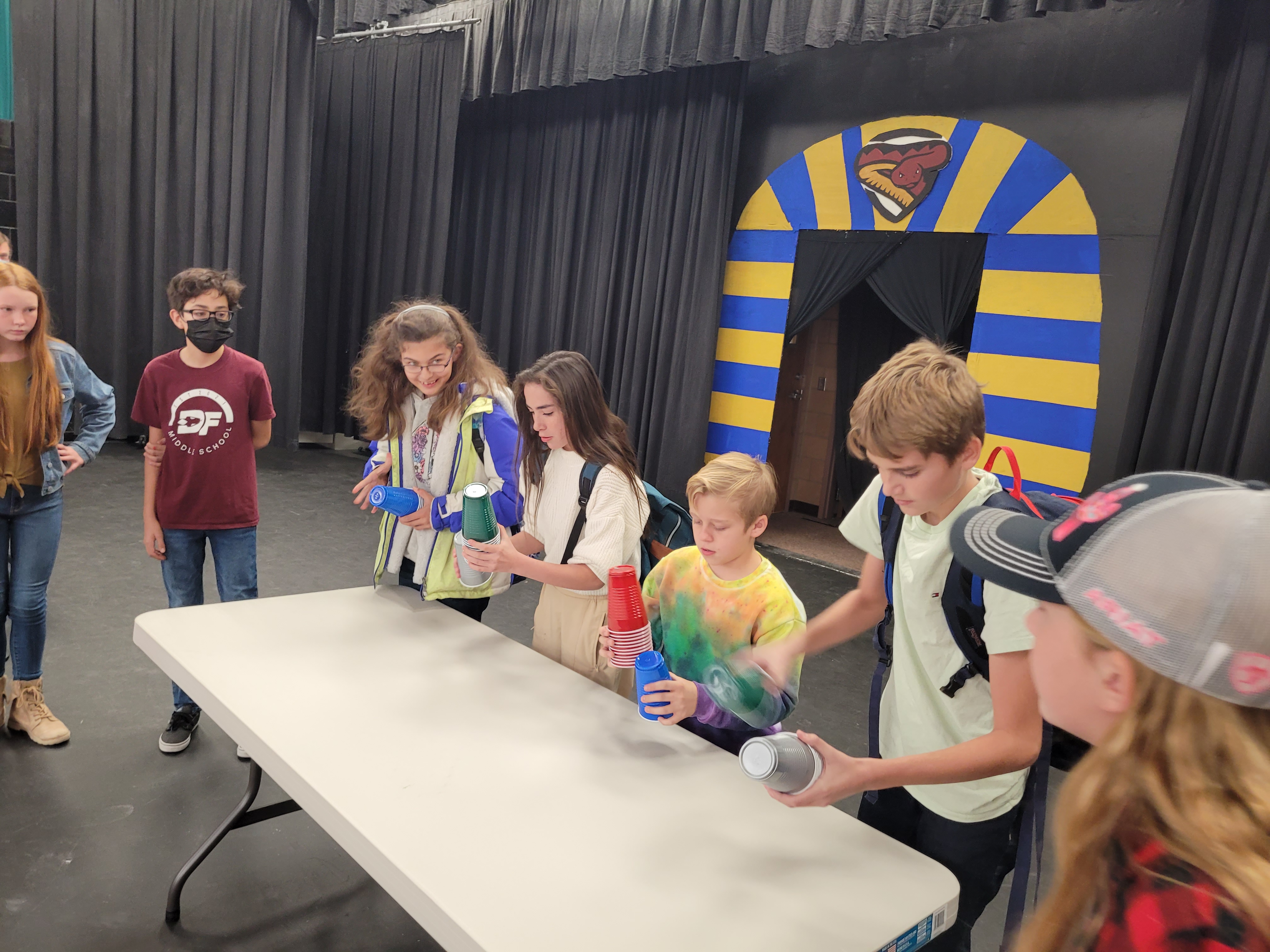 students competing in the cup stacking game