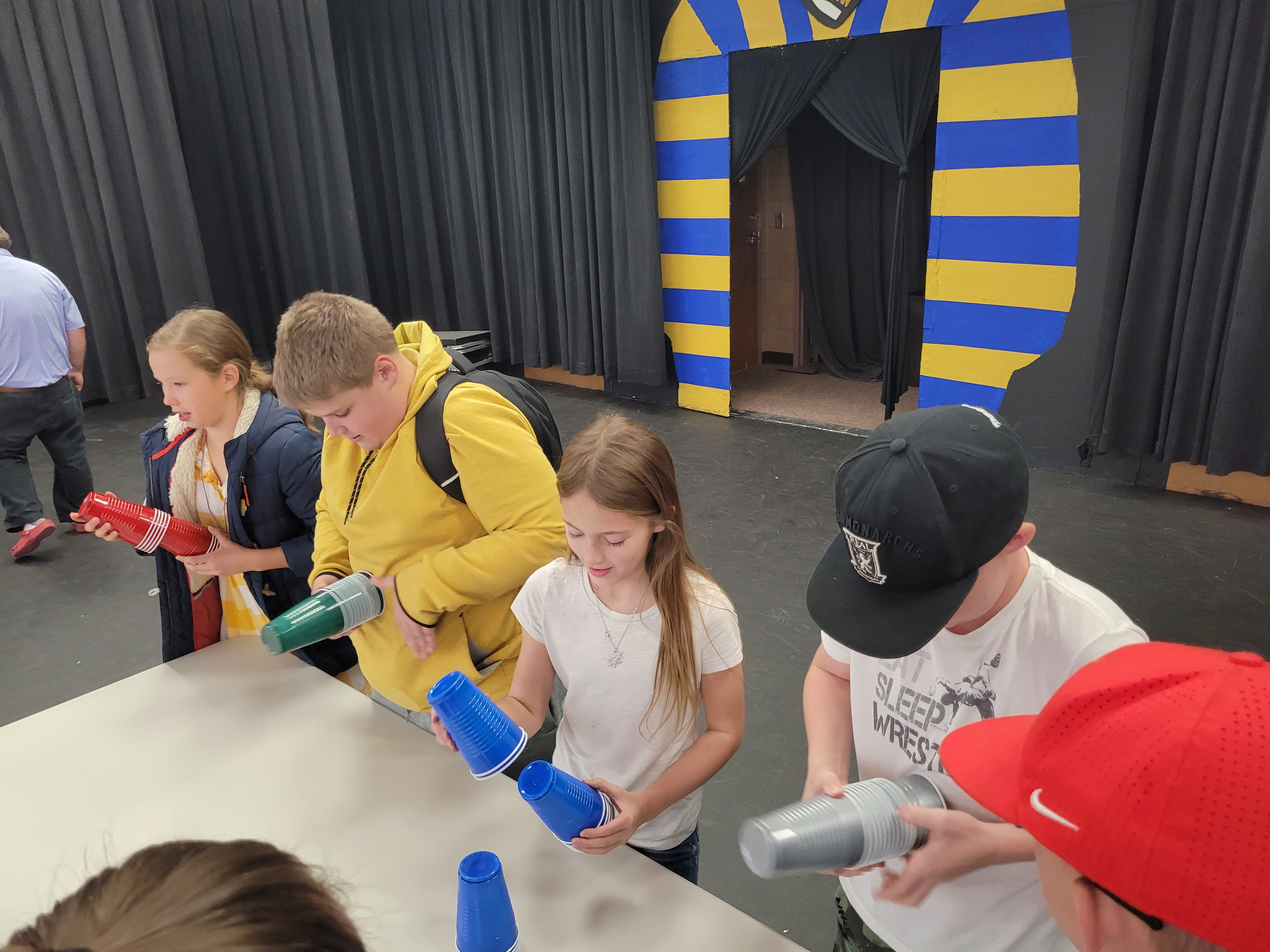 Students completing in the cup stacking game