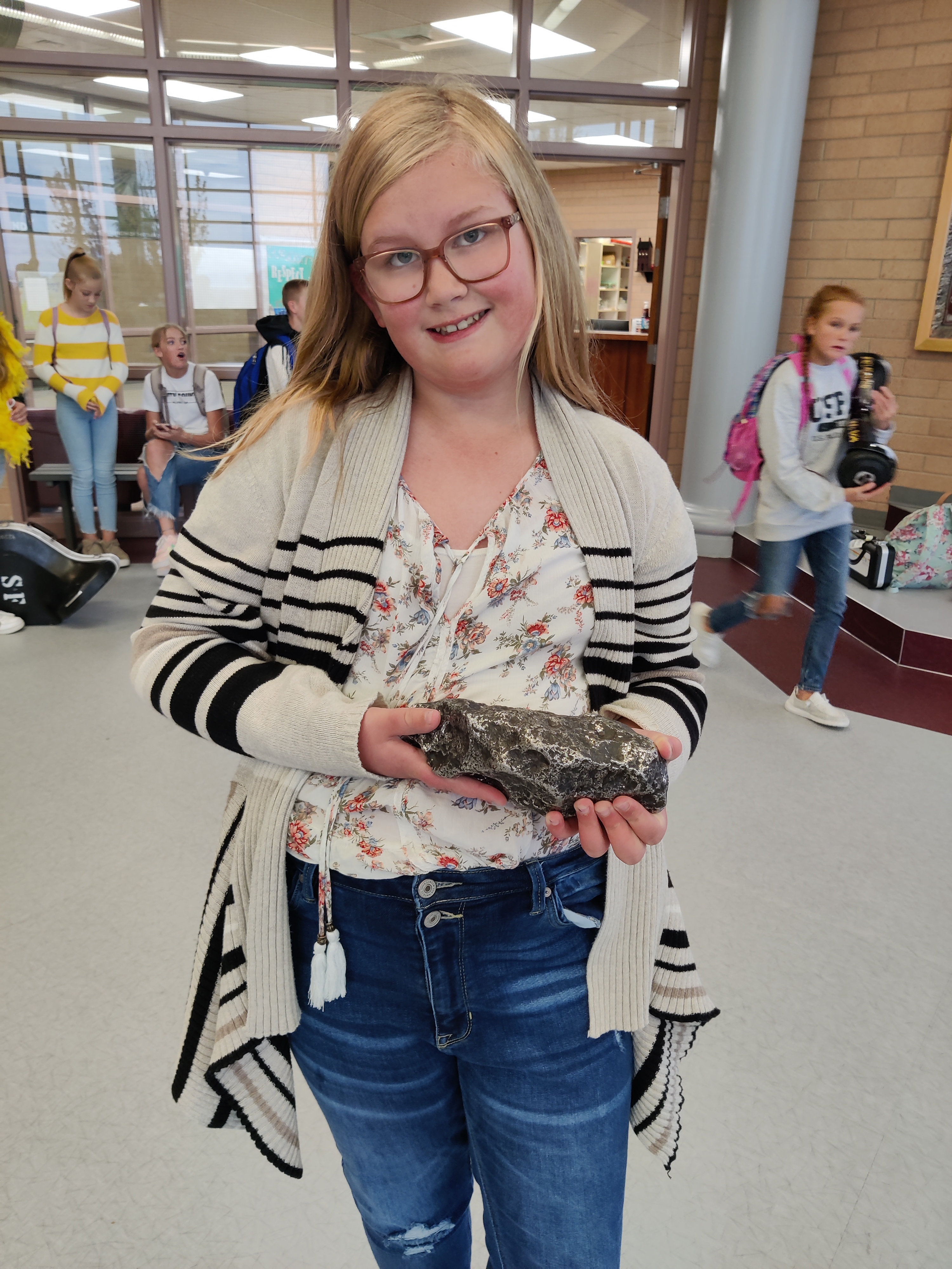 Student holds a meteorite