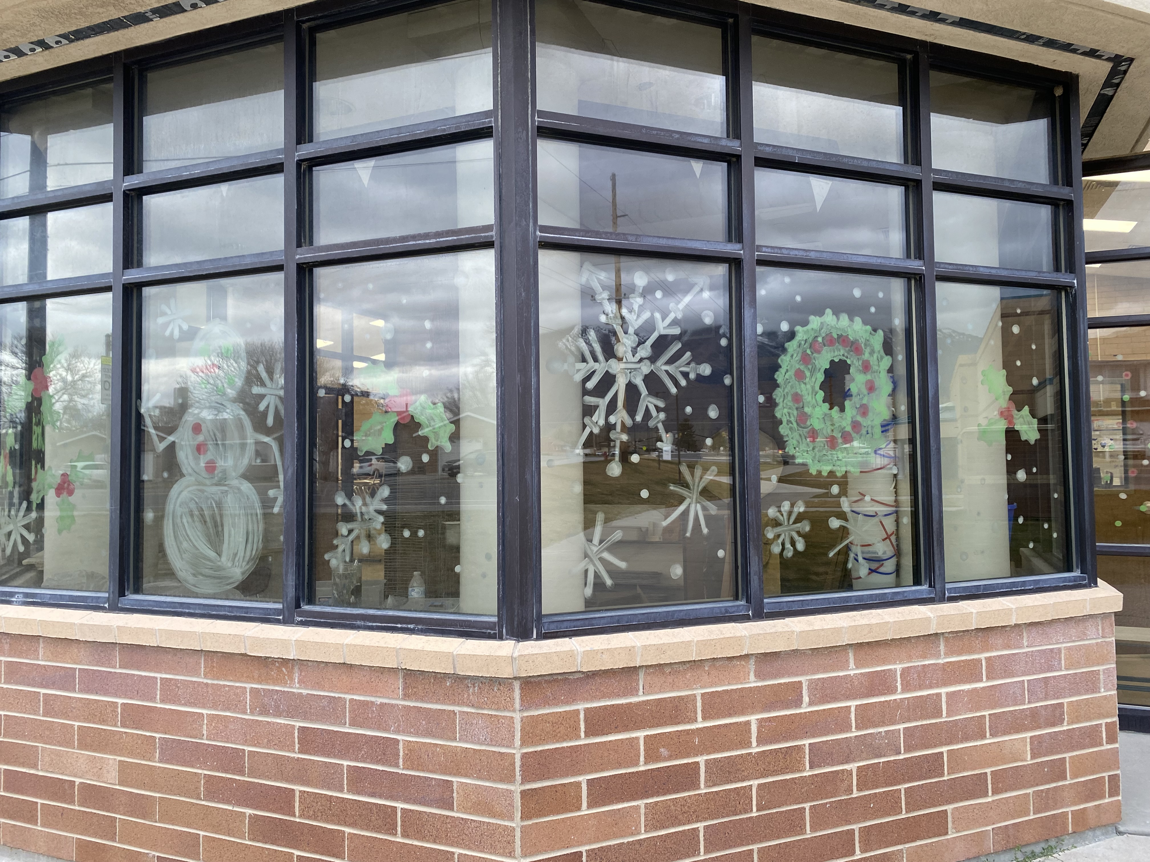 windows painted with Christmas decorations