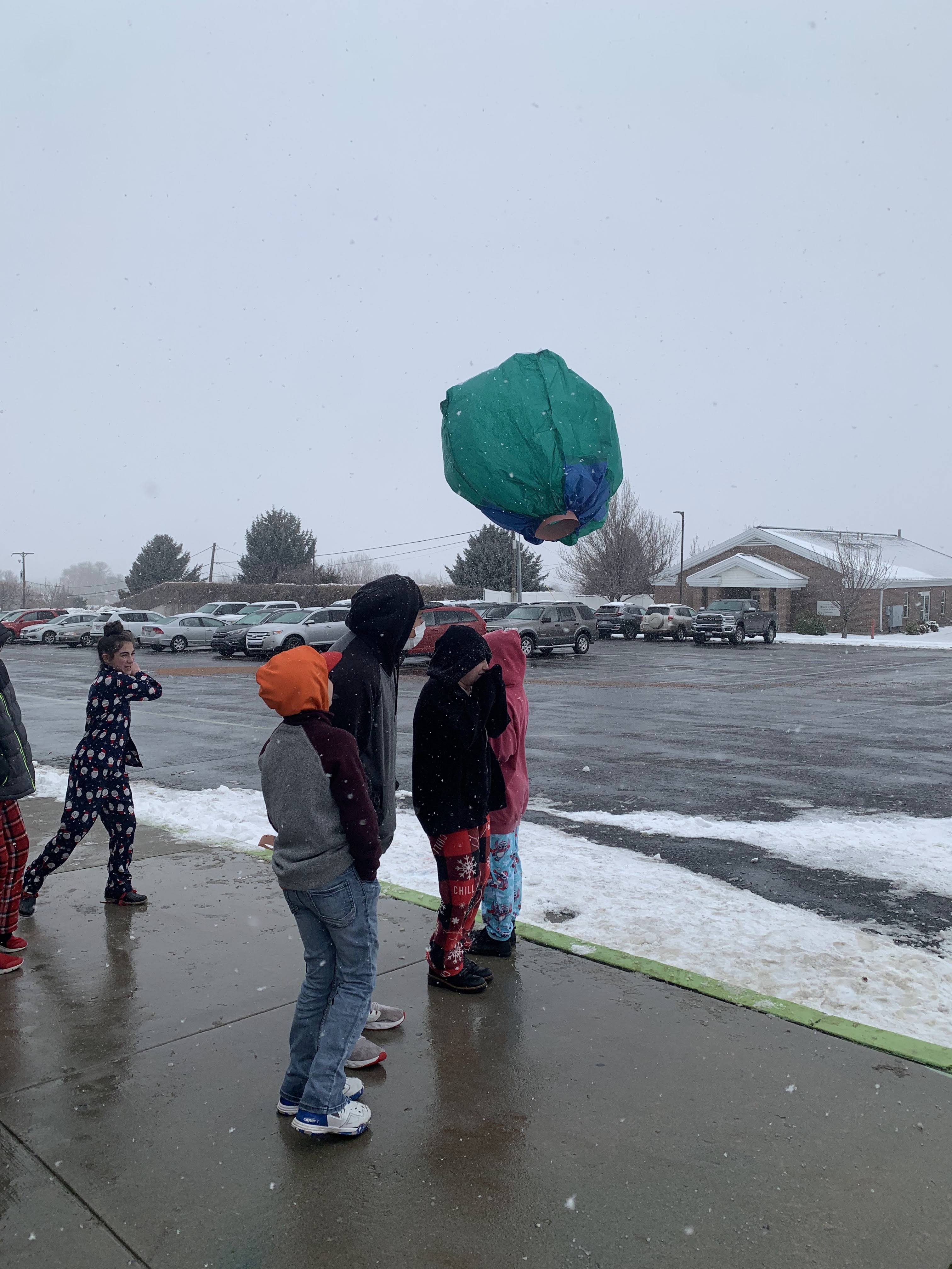 Students filling paper balloons with hot air