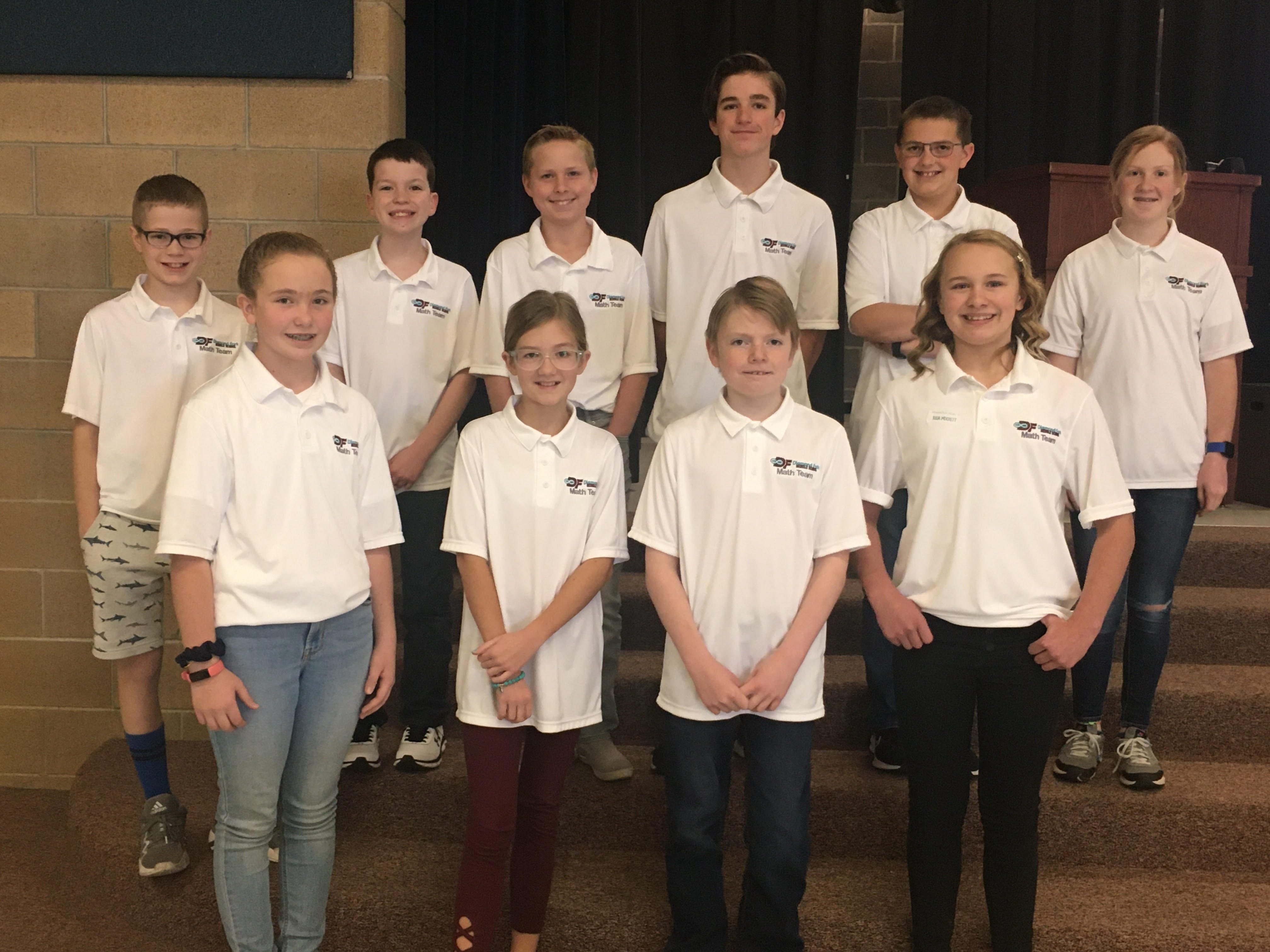 students all in white shirts ready to compete as a math team