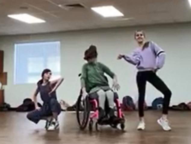 students dancing with a student in a wheelchair
