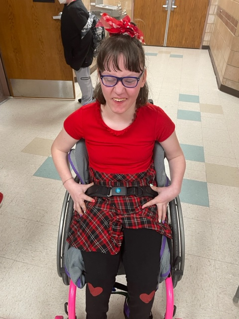 Student in a wheelchair wearing red