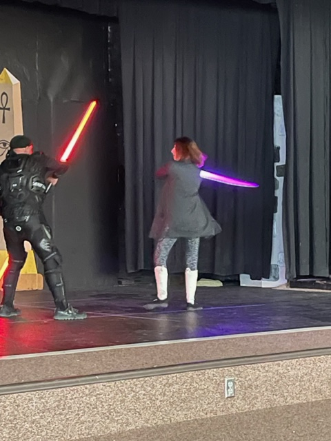 Two teachers having a light saber battle