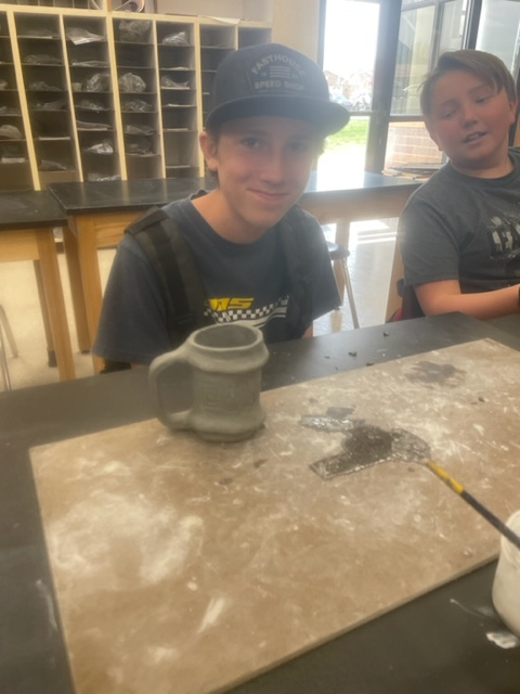 Students create pottery