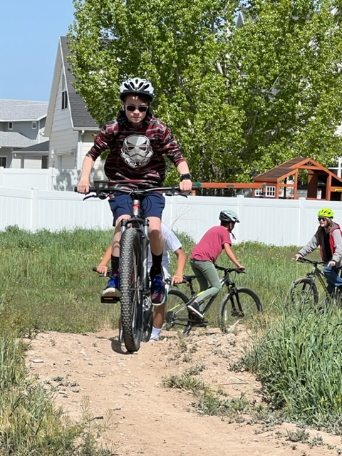 Students riding bikes in the dirt