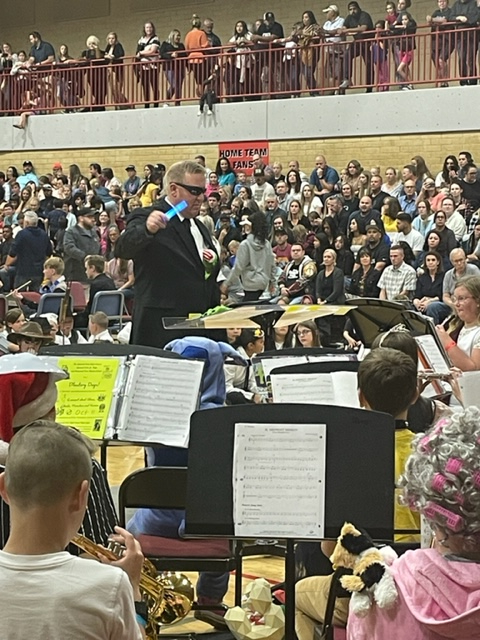 students performing in band in costumes