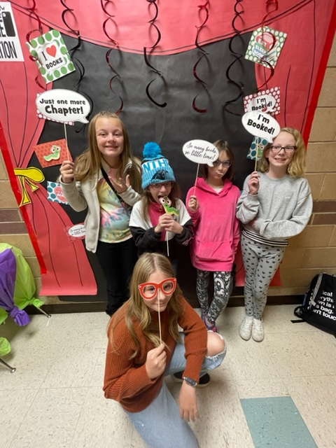 students posing at selfie stand at the book fair