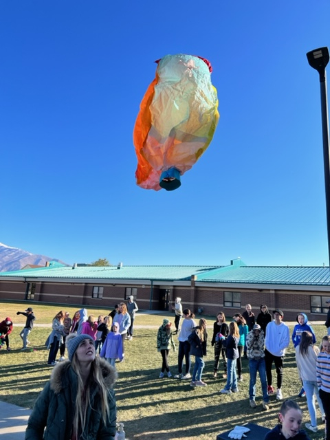 students watching hot air balloons go up 