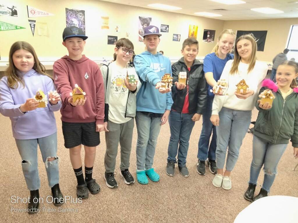 Students holding gingerbread houses