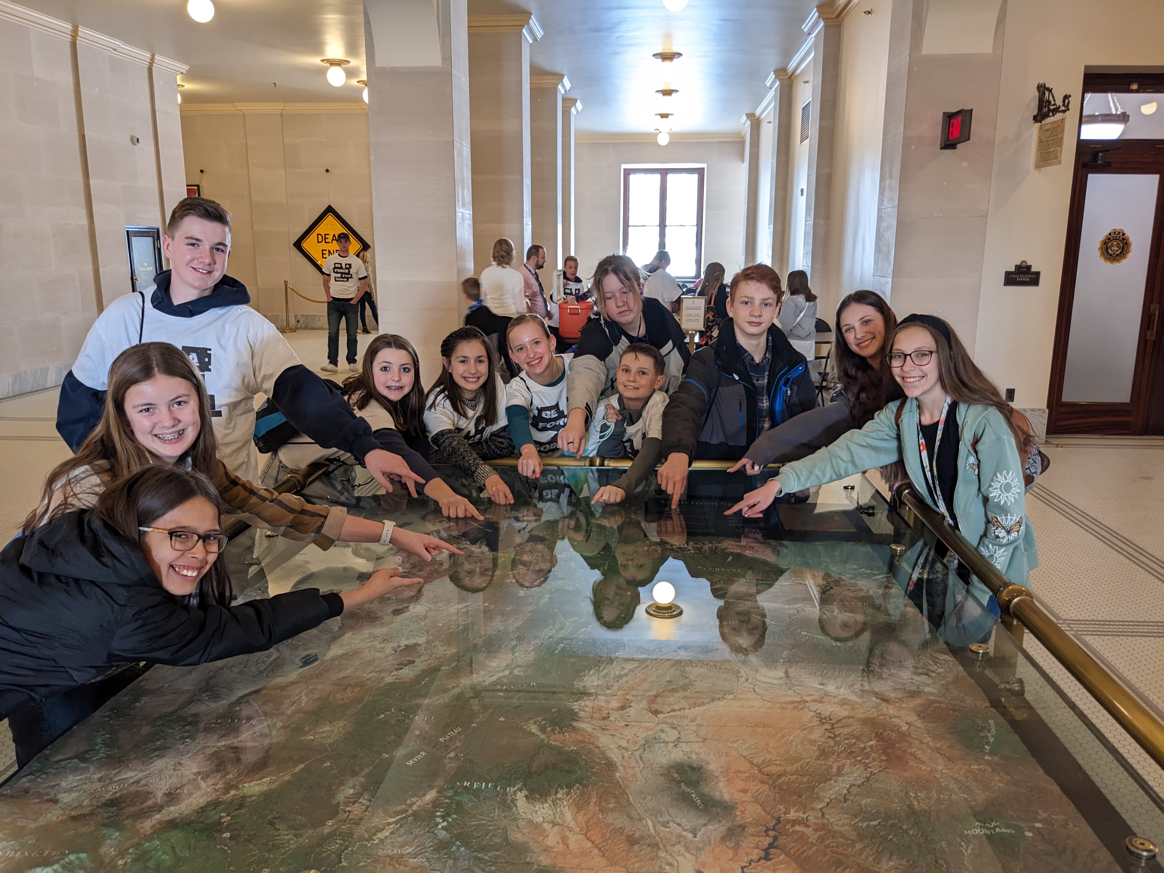 Students pointing at a map inside the state capitol 
