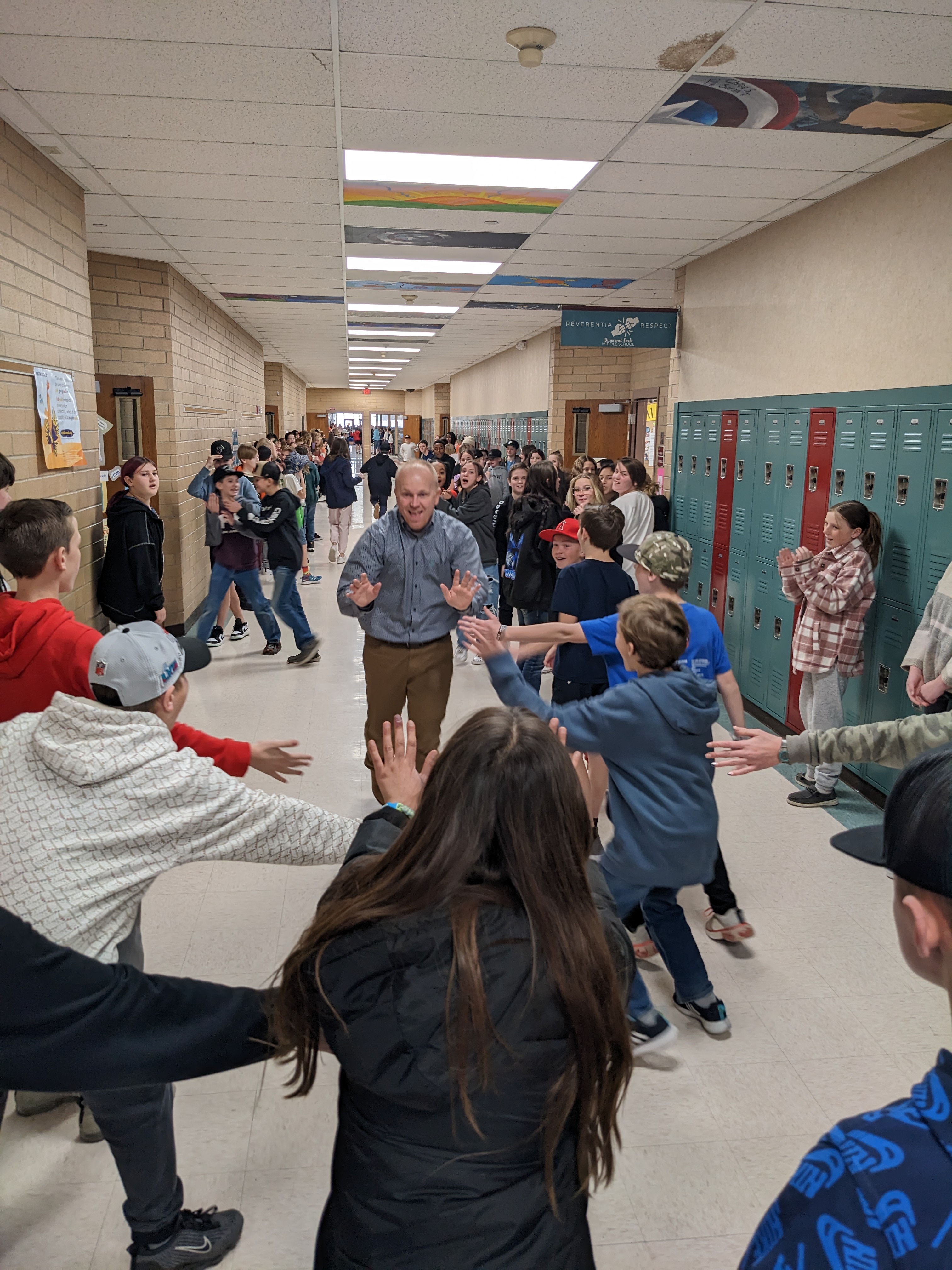 students cheering teachers in the halls