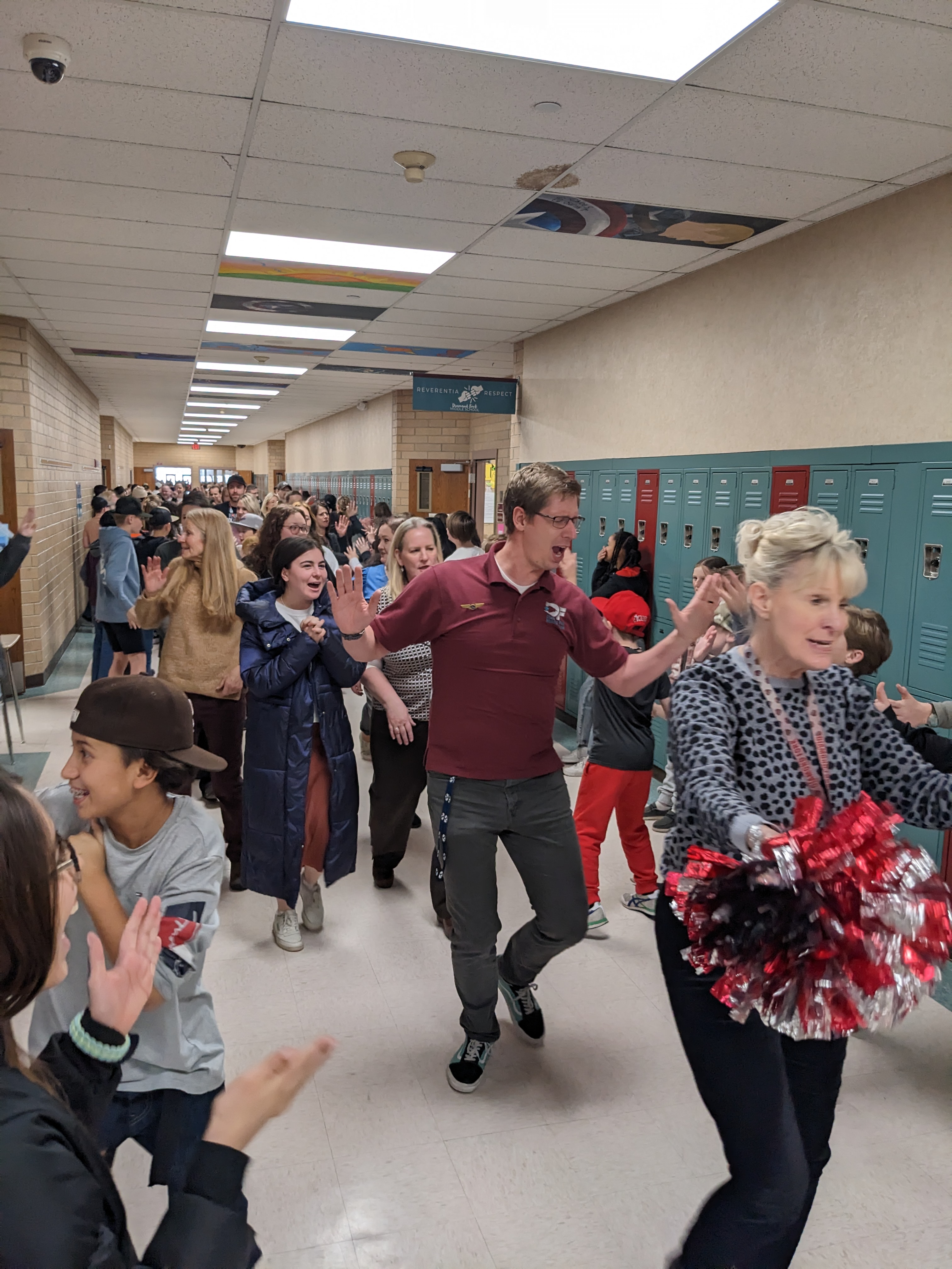 Students cheering teachers in the halls 