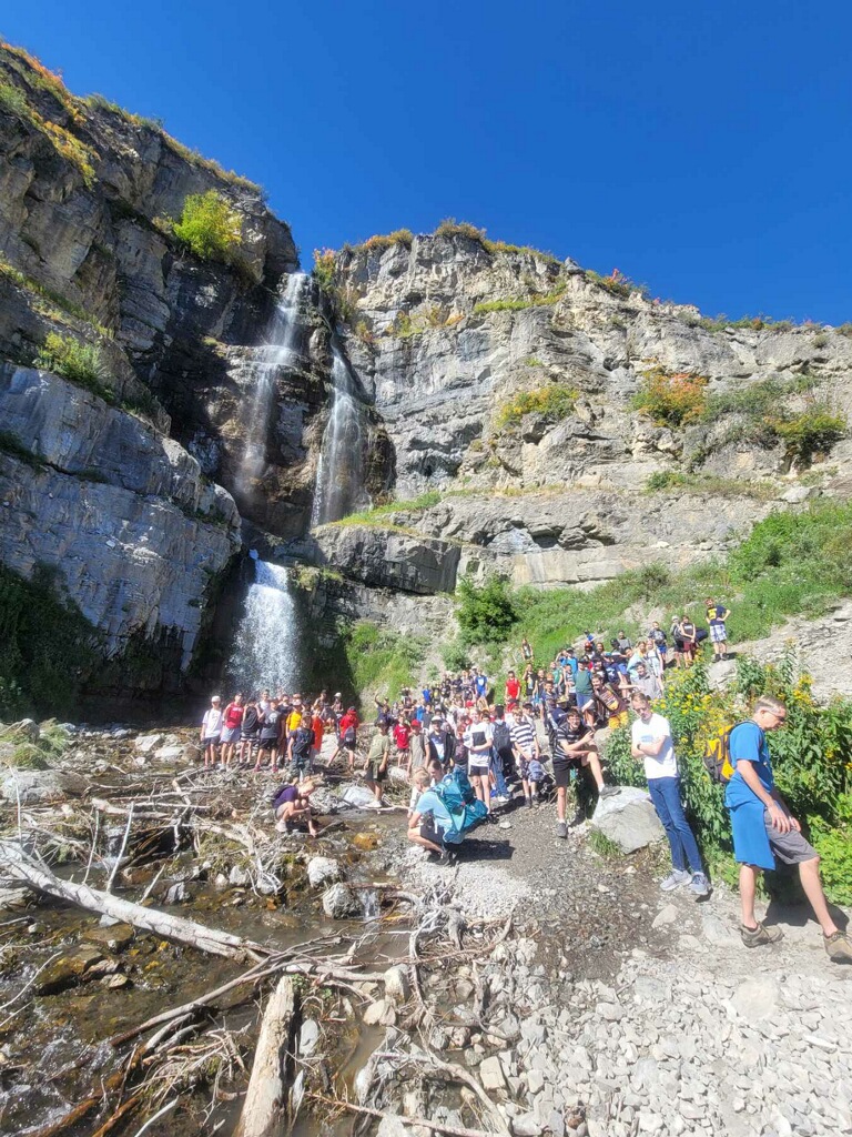 Students hiking to a waterfall