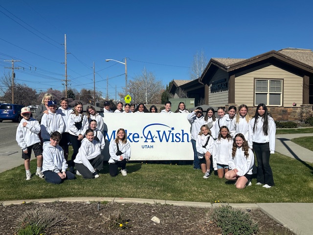 Leadership Class in matching sweatshirts standing around the Make A Wish sign. 
