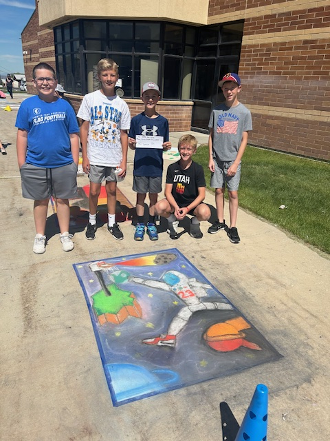 Students standing in front of their space chalk art mural! 